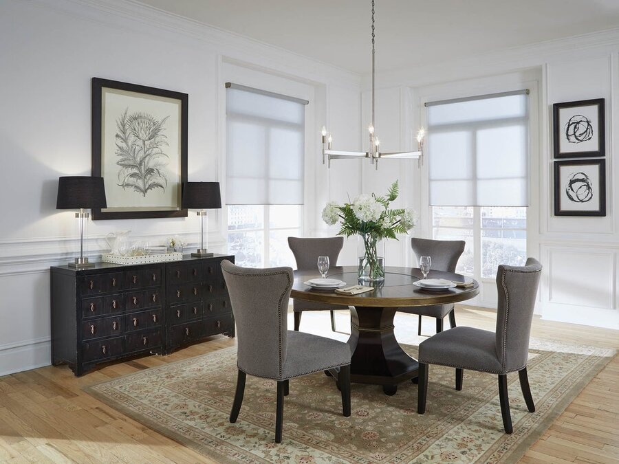 A dining room space featuring Lutron lighting and shading solutions.